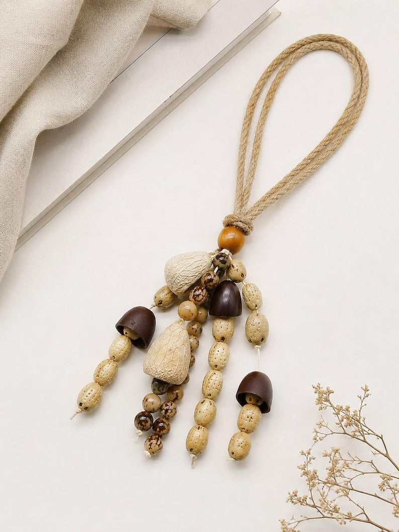 Bohemian-style curtain tie-back made of natural wood beads and cord