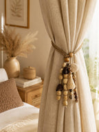 Bohemian-style curtain tie-back made of natural wood beads and cord
